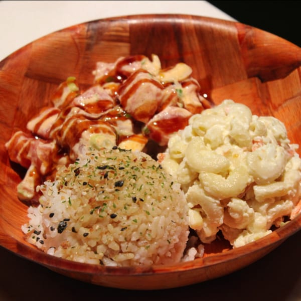 Kanaka poke bowl with tuna poke, rice, and macaroni salad in a wooden bowl.