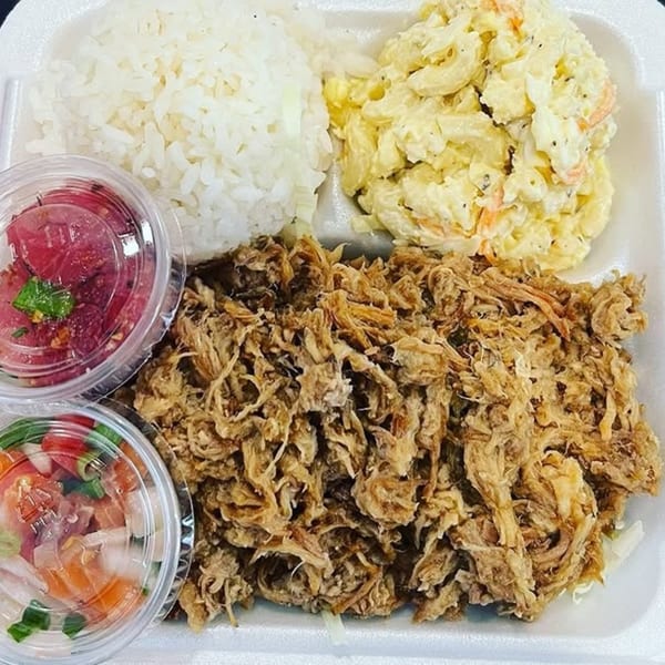 Kanaka poke plate with pulled pork, rice, macaroni salad, and two containers of poke.